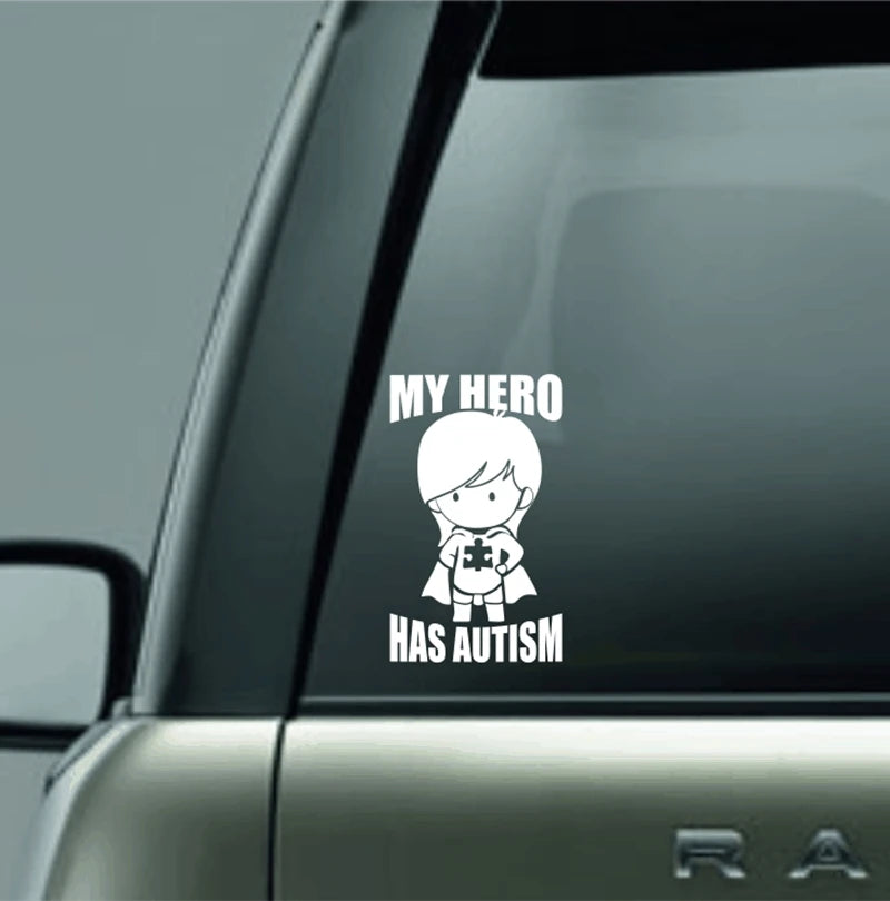 MY HERO HAS AUTISM Vinyl Decal Sticker For Car Truck Laptop Decorative Autism Awareness Decals showing a child superhero figure holding a puzzle piece symbol on a vehicle window.