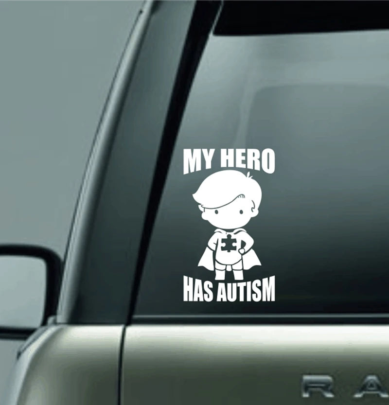 MY HERO HAS AUTISM Vinyl Decal Sticker For Car Truck Laptop Decorative Autism Awareness Decals showing a child superhero figure with a puzzle piece symbol in white on a car window.
