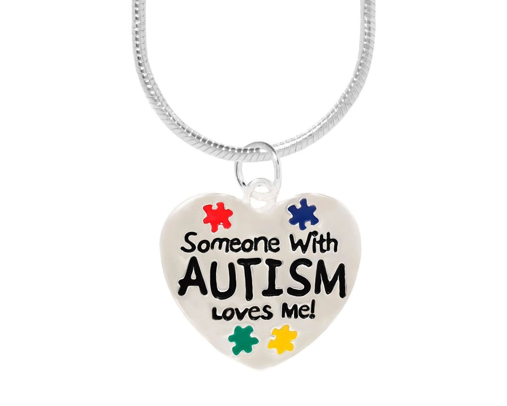 Someone With Autism Loves Me Necklace | Autism Awareness Puzzle Piece Pendant featuring a heart-shaped silver charm with colorful puzzle pieces and bold black text on a chain.