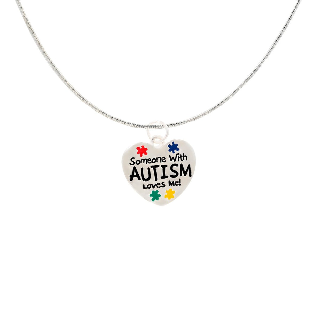 Someone With Autism Loves Me Necklace | Autism Awareness Puzzle Piece Pendant featuring a silver heart pendant with colorful puzzle pieces and bold text on a delicate chain.