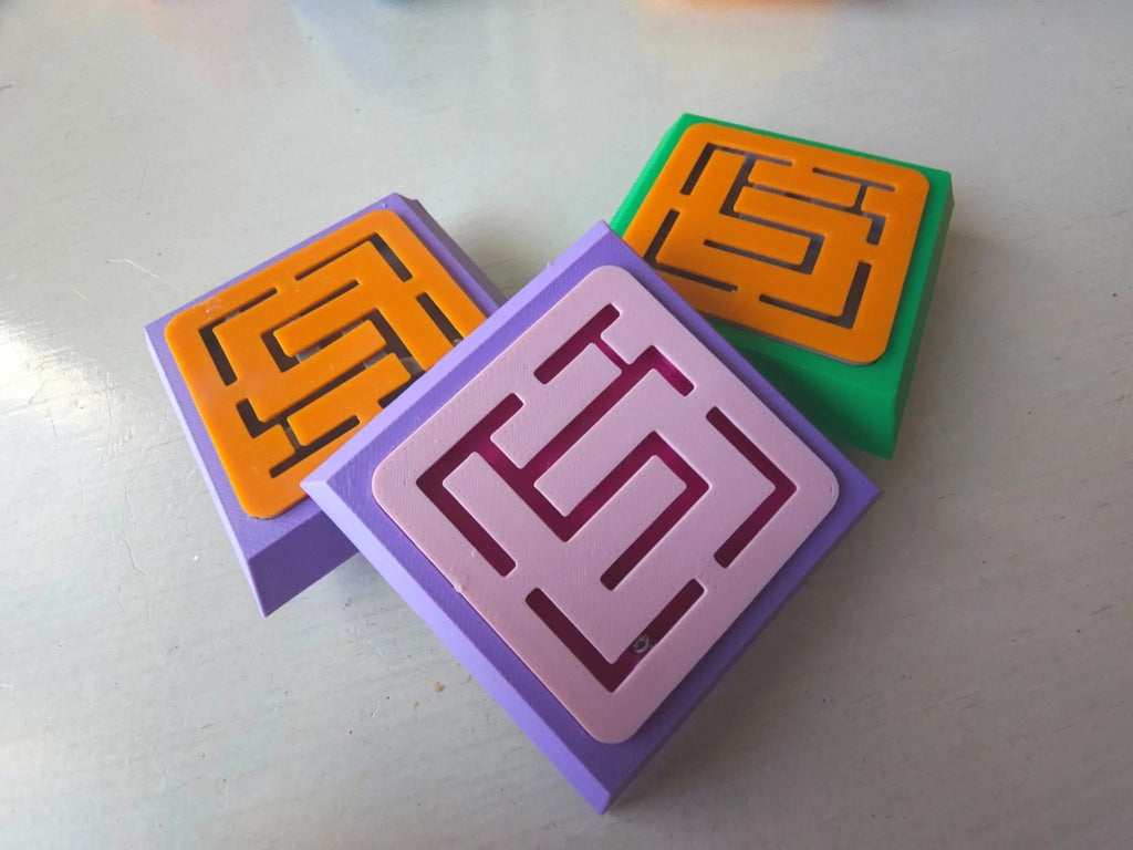 Three colorful modular cubes with maze-like cutouts on each face, designed as engaging components of the Modular Fidget Cube | Swappable Sensory Toy for Kids 4+ | 4 Inch, ideal for sensory play.