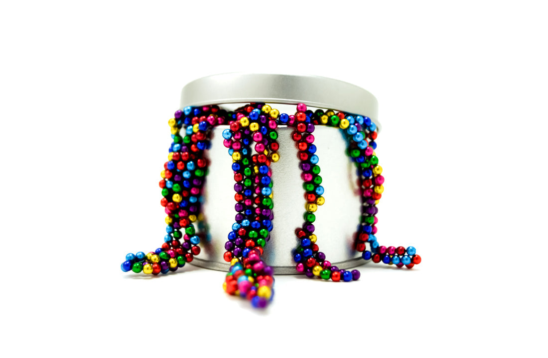 Brightly colored Magnetic Balls Fidget Toy | 3MM Neodymium Stress Relief Balls for Adults & Teens spilling from a silver container, designed for sensory and calming use.