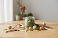 Dinosaur playdough sensory kit with fossils and bones on a wooden table