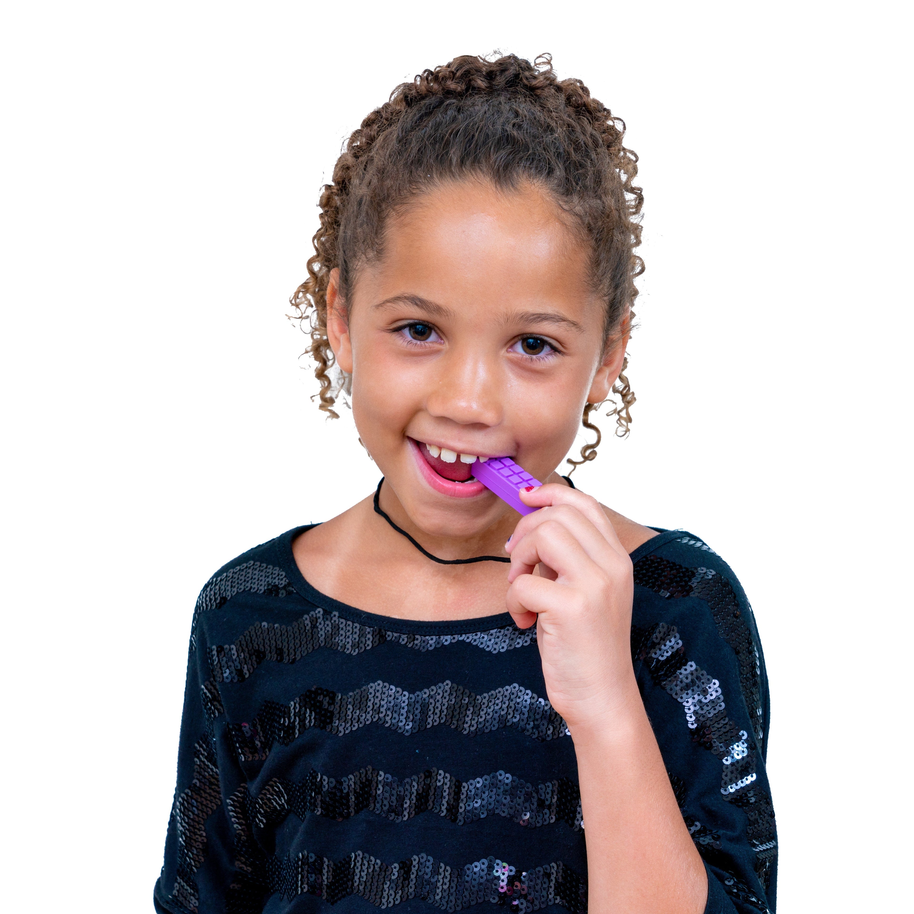 Young girl wearing a Chewy Blocks Necklace - Calming Textured Chewy Silicone Pendant for Autism & Oral Motor Special Needs Kids, gently biting the purple pendant for sensory relief.